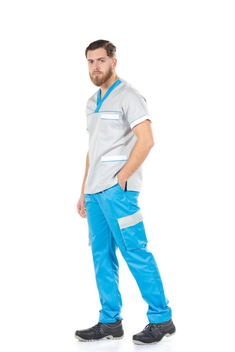 Trabalhador da área da indústria vestido com uma calça azul com bolso lateral na perna e uma túnica unissexo de trabalho fabricada pela Unifardas